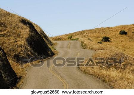 Stock Photo - Road passing through a landscape. Fotosearch