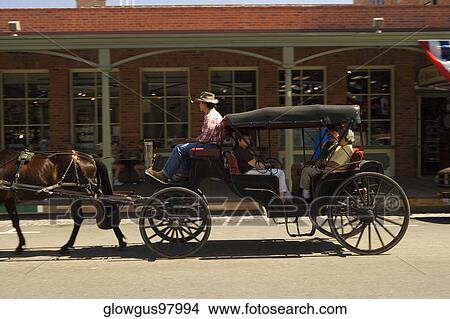 Side profile of a carriage in front of a store View Large Photo Image Picture - Side profile of a carriage in front of a store. Fotosearch