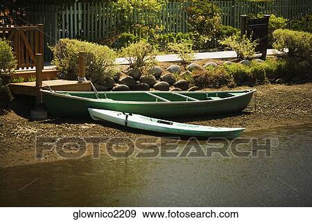 Side profile of a rowboat on a shore View Large Photo Image Stock Photo - Side profile of a rowboat on a shore. Fotosearch