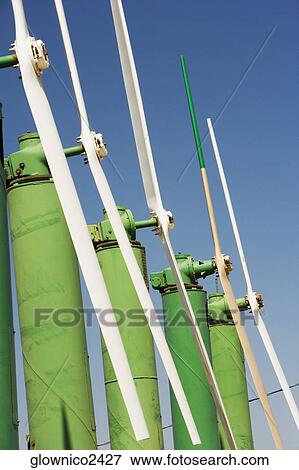 Side profile of an array of windmills on a farm View Large Photo Image Stock Photo - Side profile of an array of windmills on a farm. Fotosearch