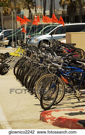 Side profile of cycles parked on a sidewalk View Large Photo Image Stock Image - Side profile of cycles parked on a sidewalk. Fotosearch