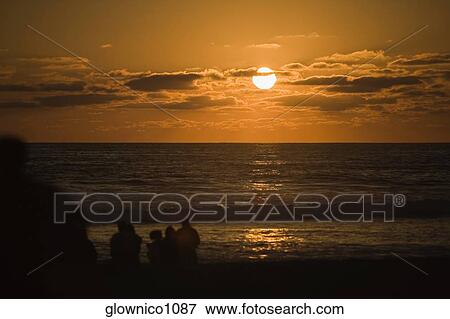 Silhouette of people on the beach at dusk, San Diego, California, USA View Large Photo Image Stock Photo - Silhouette of people on the beach at dusk, San Diego, California, USA. Fotosearch