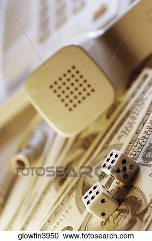 Telephone receiver and dice on top of United States hundred Dollar bills, close-up View Large Photo Image Stock Image - Telephone receiver and dice on top of United States hundred Dollar bills, close-up. Fotosearch