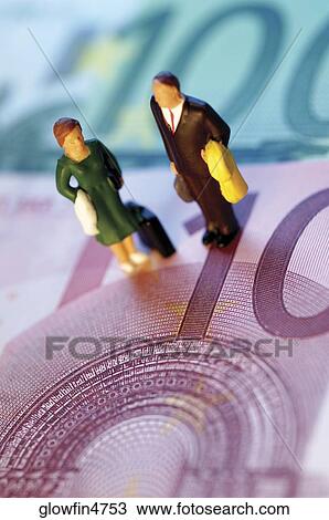 Toy businessman and businesswoman standing on top of Euro bank notes View Large Photo Image Stock Image - Toy businessman and businesswoman standing on top of Euro bank notes. Fotosearch