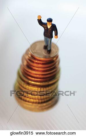 Toy man on top of stack of coins View Large Photo Image Stock Photography - Toy man on top of stack of coins. Fotosearch