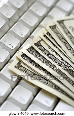 United States one hundred dollar bills on top of computer keyboard, close-up View Large Photo Image Stock Image - United States one hundred dollar bills on top of computer keyboard, close-up. Fotosearch