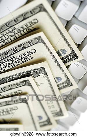 United States one hundred dollar bills on top of computer keyboard, close-up View Large Photo Image Stock Photo - United States one hundred dollar bills on top of computer keyboard, close-up. Fotosearch