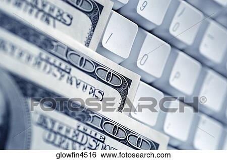 United States one hundred dollar bills on top of computer keyboard, close-up View Large Photo Image Stock Photograph - United States one hundred dollar bills on top of computer keyboard, close-up. Fotosearch