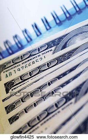 United States one hundred dollar bills on top of spiral bound notebook View Large Photo Image Stock Photography - United States one hundred dollar bills on top of spiral bound notebook. Fotosearch
