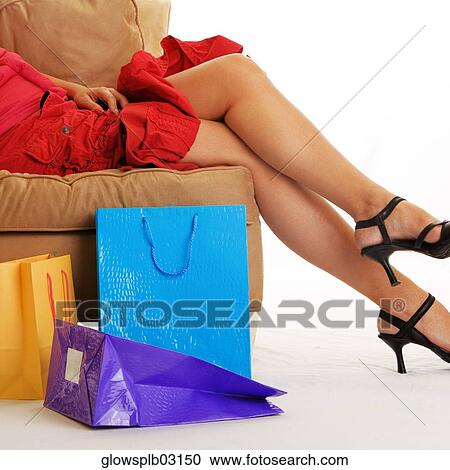 Woman lying on couch with shopping bags on floor View Large Photo Image Stock Image - Woman lying on couch with shopping bags on floor. Fotosearch