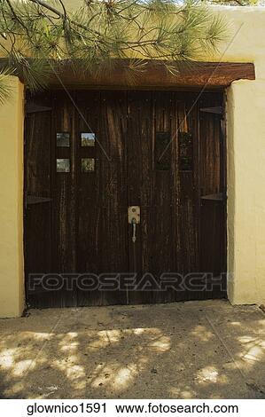 Wooden doors on a stucco building View Large Photo Image Stock Image - Wooden doors on a stucco building. Fotosearch