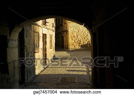 Arched gateway leading to a cobblestone alley, Spain View Large Photo Image Picture - Arched gateway leading to a cobblestone alley, Spain. Fotosearch
