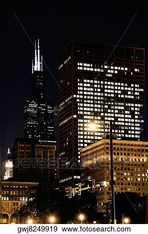 Stock Photo - Buildings lit up at night, Chicago, Illinois, USA. Fotosearch