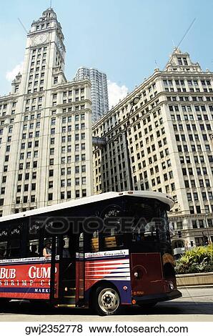 Stock Photo - Bus parked in front of a building, Wrigley Building, Chicago, Illinois, USA. Fotosearch