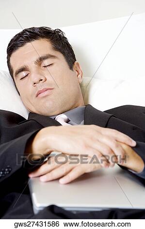Stock Photograph - Businessman sleeping with a laptop. Fotosearch