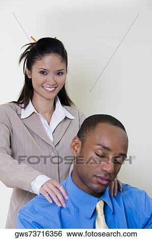 Businessman sleeping with a businesswoman standing behind him View Large Photo Image Stock Photograph - Businessman sleeping with a businesswoman standing behind him. Fotosearch