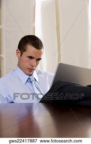 Businessman using a laptop View Large Photo Image Stock Photo - Businessman using a laptop. Fotosearch