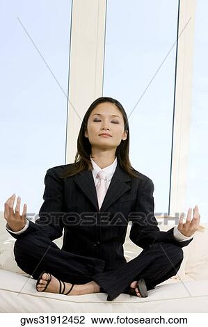 Businesswoman sitting in the lotus position View Large Photo Image Stock Image - Businesswoman sitting in the lotus position. Fotosearch