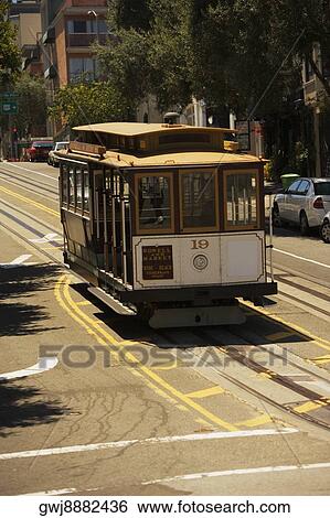 Cable car moving on a railroad track View Large Photo Image Stock Photograph - Cable car moving on a railroad track. Fotosearch