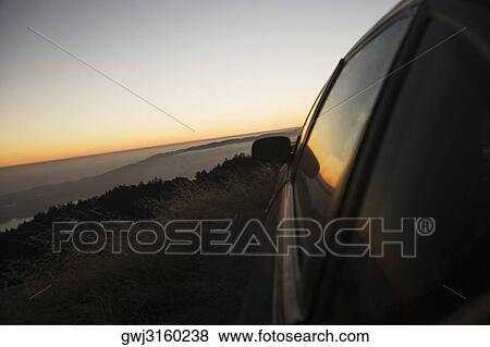 Car parked on a hill at dusk View Large Photo Image Stock Photo - Car parked on a hill at dusk. Fotosearch