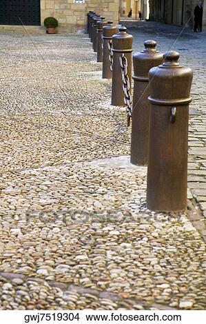 Picture - Chain-link fence on a sidewalk, Spain. Fotosearch