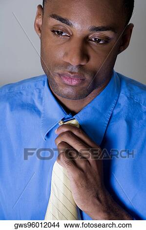 Close-up of a businessman adjusting his tie View Large Photo Image Picture - Close-up of a businessman adjusting his tie. Fotosearch
