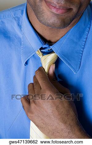 Close-up of a businessman adjusting his tie View Large Photo Image Stock Image - Close-up of a businessman adjusting his tie. Fotosearch