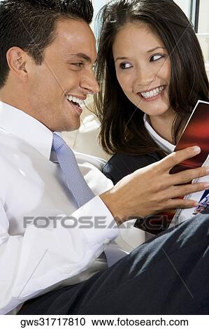 Close-up of a businessman and a businesswoman reading a book View Large Photo Image Stock Image - Close-up of a businessman and a businesswoman reading a book. Fotosearch