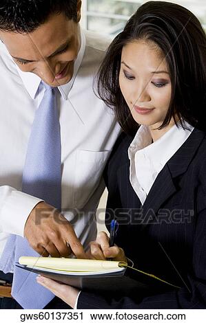 Close-up of a businessman dictating notes to his secretary View Large Photo Image Stock Image - Close-up of a businessman dictating notes to his secretary. Fotosearch