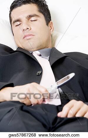 Close-up of a businessman holding a mobile phone View Large Photo Image Stock Photo - Close-up of a businessman holding a mobile phone. Fotosearch