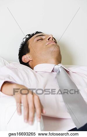 Close-up of a businessman sleeping in an armchair View Large Photo Image Stock Photography - Close-up of a businessman sleeping in an armchair. Fotosearch