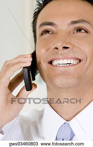 Close-up of a businessman talking on a mobile phone View Large Photo Image Stock Image - Close-up of a businessman talking on a mobile phone. Fotosearch