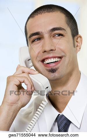 Close-up of a businessman talking on the telephone View Large Photo Image Picture - Close-up of a businessman talking on the telephone. Fotosearch