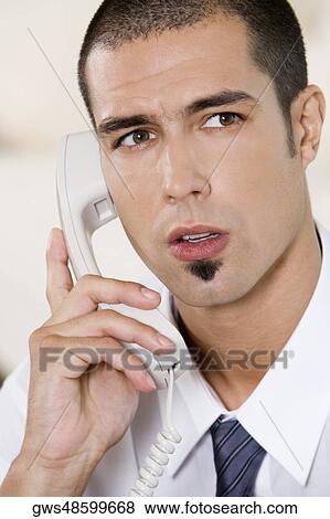 Close-up of a businessman talking on the telephone View Large Photo Image Stock Photo - Close-up of a businessman talking on the telephone. Fotosearch