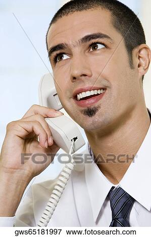 Close-up of a businessman talking on the telephone View Large Photo Image Stock Photo - Close-up of a businessman talking on the telephone. Fotosearch
