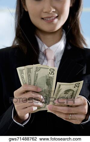 Close-up of a businesswoman counting American paper currency View Large Photo Image Stock Image - Close-up of a businesswoman counting American paper currency. Fotosearch
