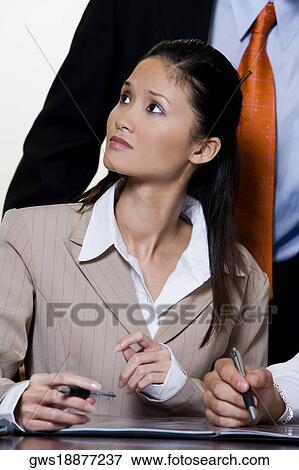 Stock Photo - Close-up of a businesswoman looking up. Fotosearch