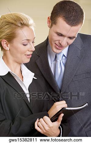Close-up of a businesswoman talking to a businessman View Large Photo Image Stock Image - Close-up of a businesswoman talking to a businessman. Fotosearch