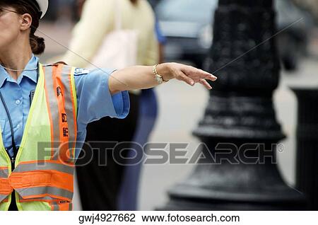 Stock Image - Close-up of a crossing guard directing traffic, Chicago, Illinois, USA. Fotosearch