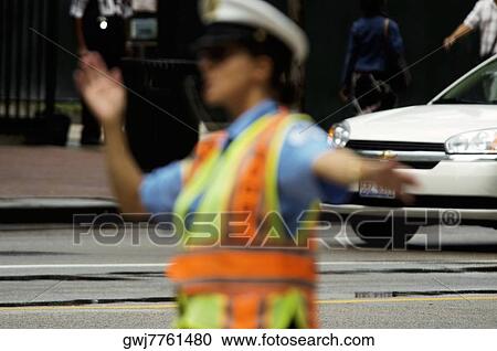 Close-up of a crossing guard directing traffic, Chicago, Illinois, USA View Large Photo Image Stock Image - Close-up of a crossing guard directing traffic, Chicago, Illinois, USA. Fotosearch
