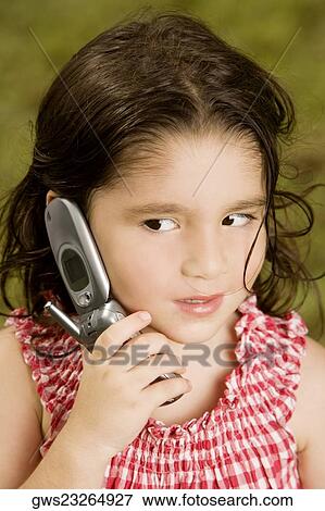 Stock Photo - Close-up of a girl talking on a mobile phone. Fotosearch