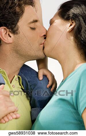 Close-up of a mid adult man kissing a young woman View Large Photo Image Stock Photo - Close-up of a mid adult man kissing a young woman. Fotosearch
