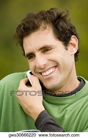 Stock Image - Close-up of a mid adult man talking on a mobile phone. Fotosearch