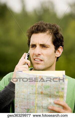 Close-up of a mid adult man talking on a mobile phone View Large Photo Image Stock Photo - Close-up of a mid adult man talking on a mobile phone. Fotosearch