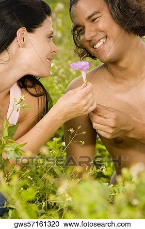 Close-up of a young couple in a garden View Large Photo Image Stock Image - Close-up of a young couple in a garden. Fotosearch