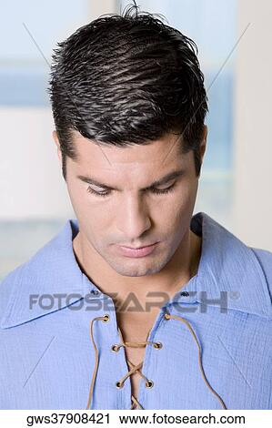Close-up of a young man looking down View Large Photo Image Stock Image - Close-up of a young man looking down. Fotosearch