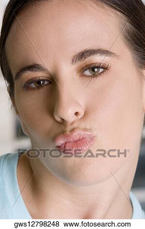 Close-up of a young woman puckering her lips View Large Photo Image Stock Photo - Close-up of a young woman puckering her lips. Fotosearch
