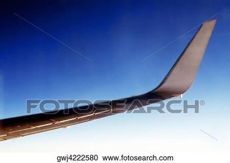 Close-up of an airplane wing against blue sky View Large Photo Image Stock Image - Close-up of an airplane wing against blue sky. Fotosearch