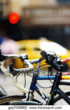 Close-up of bicycles on a bike rack View Large Photo Image Stock Image - Close-up of bicycles on a bike rack. Fotosearch