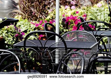 Close-up of tables and chairs at an outdoor cafe View Large Photo Image Stock Image - Close-up of tables and chairs at an outdoor cafe. Fotosearch